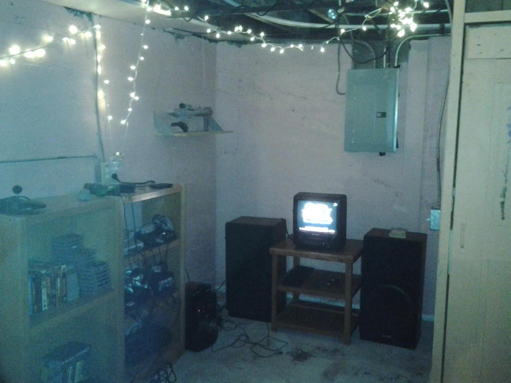 A small CRT TV and a variety of retro consoles.