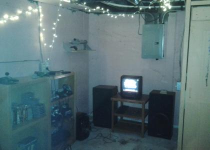 A small CRT TV and a variety of retro consoles.