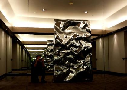 A large metal sculpture between two mirrors